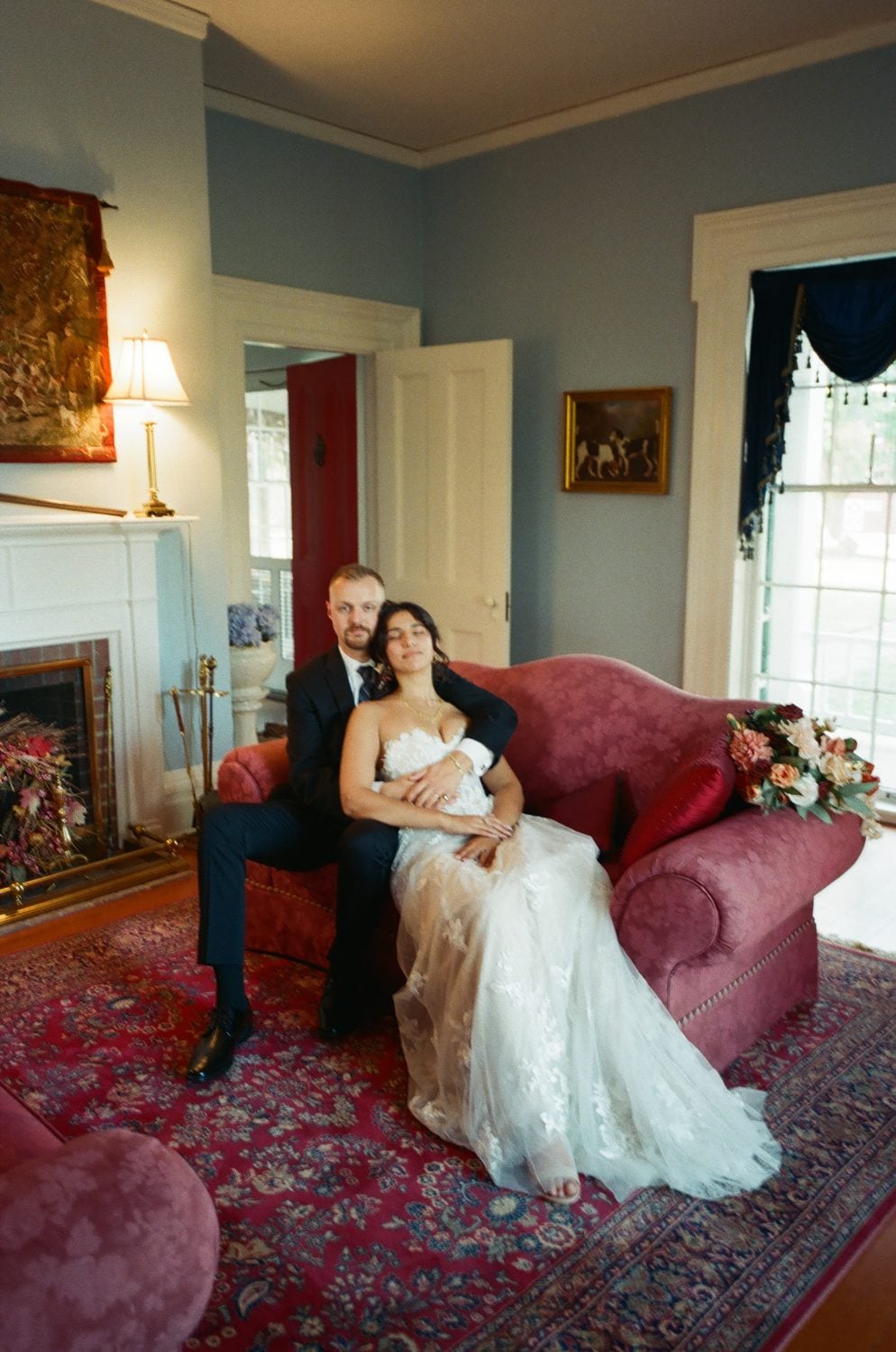 Film photograph of a red velvet sofa in soft light