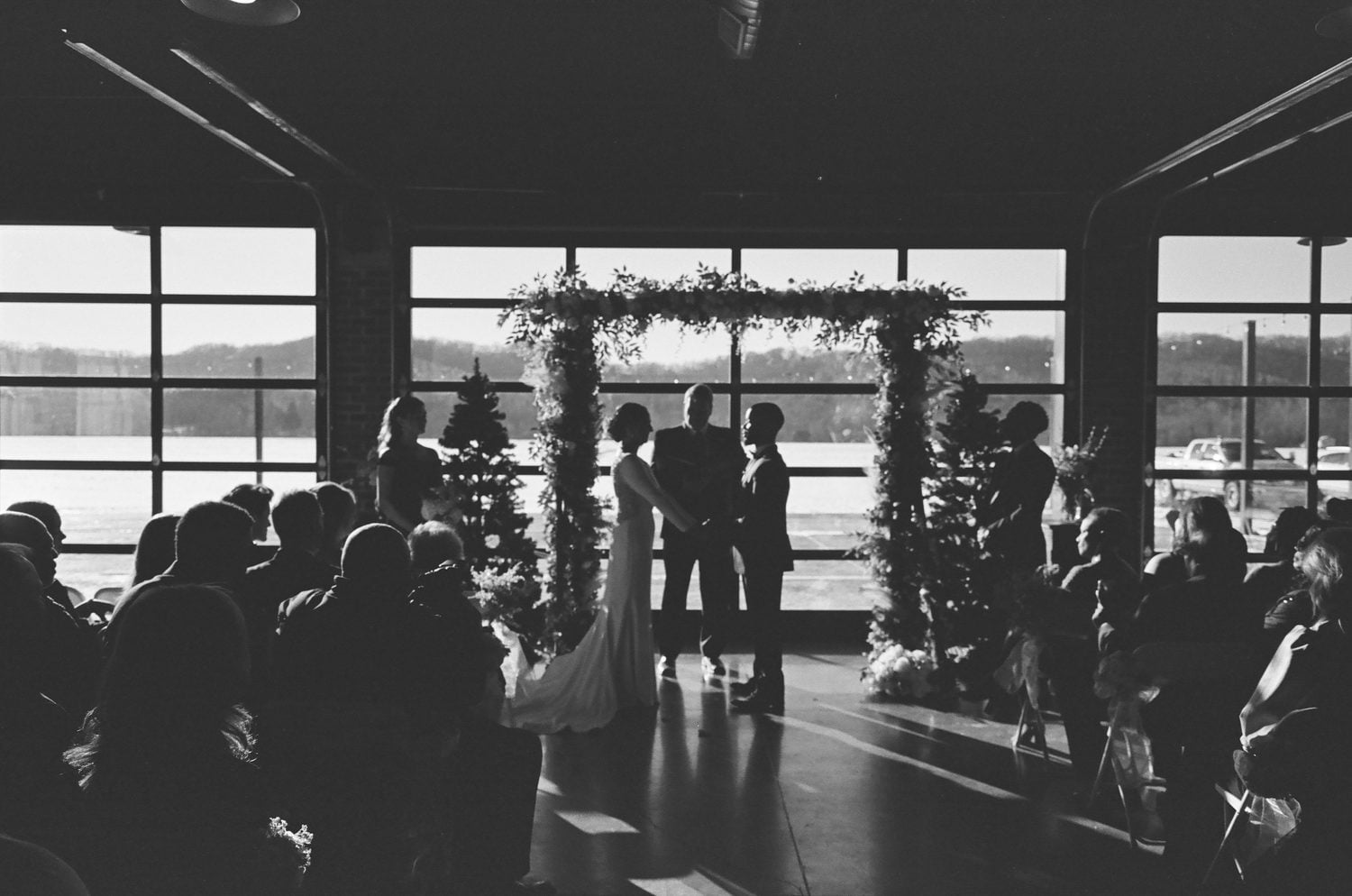Black and white film photograph of the ceremony in silhouette