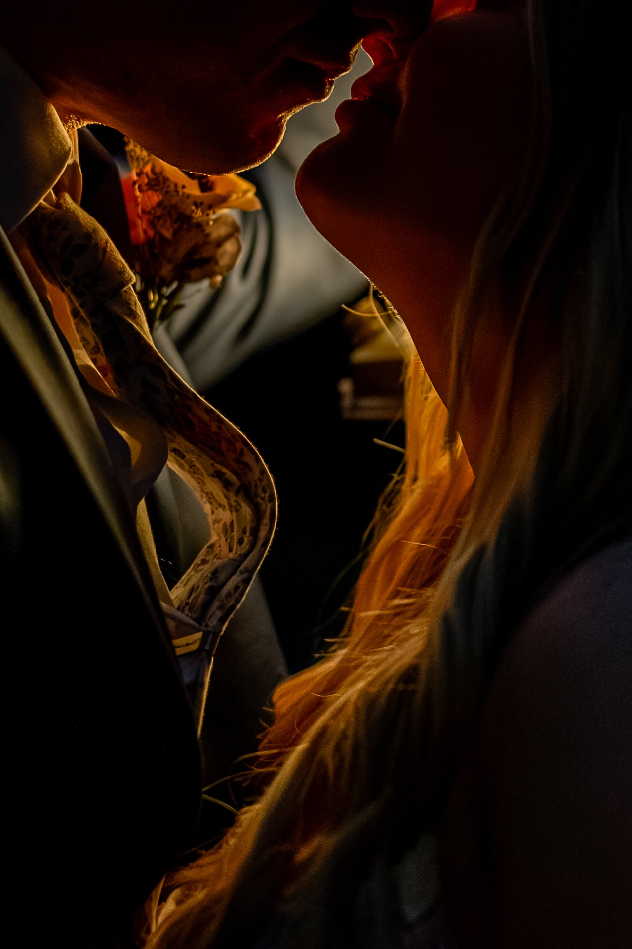 Close up of a couple about to kiss, backlit by warm golden sunset light