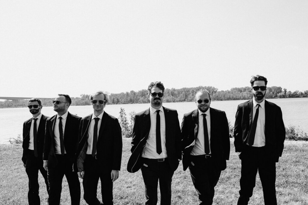 Groom and groomsmen by the lake. 